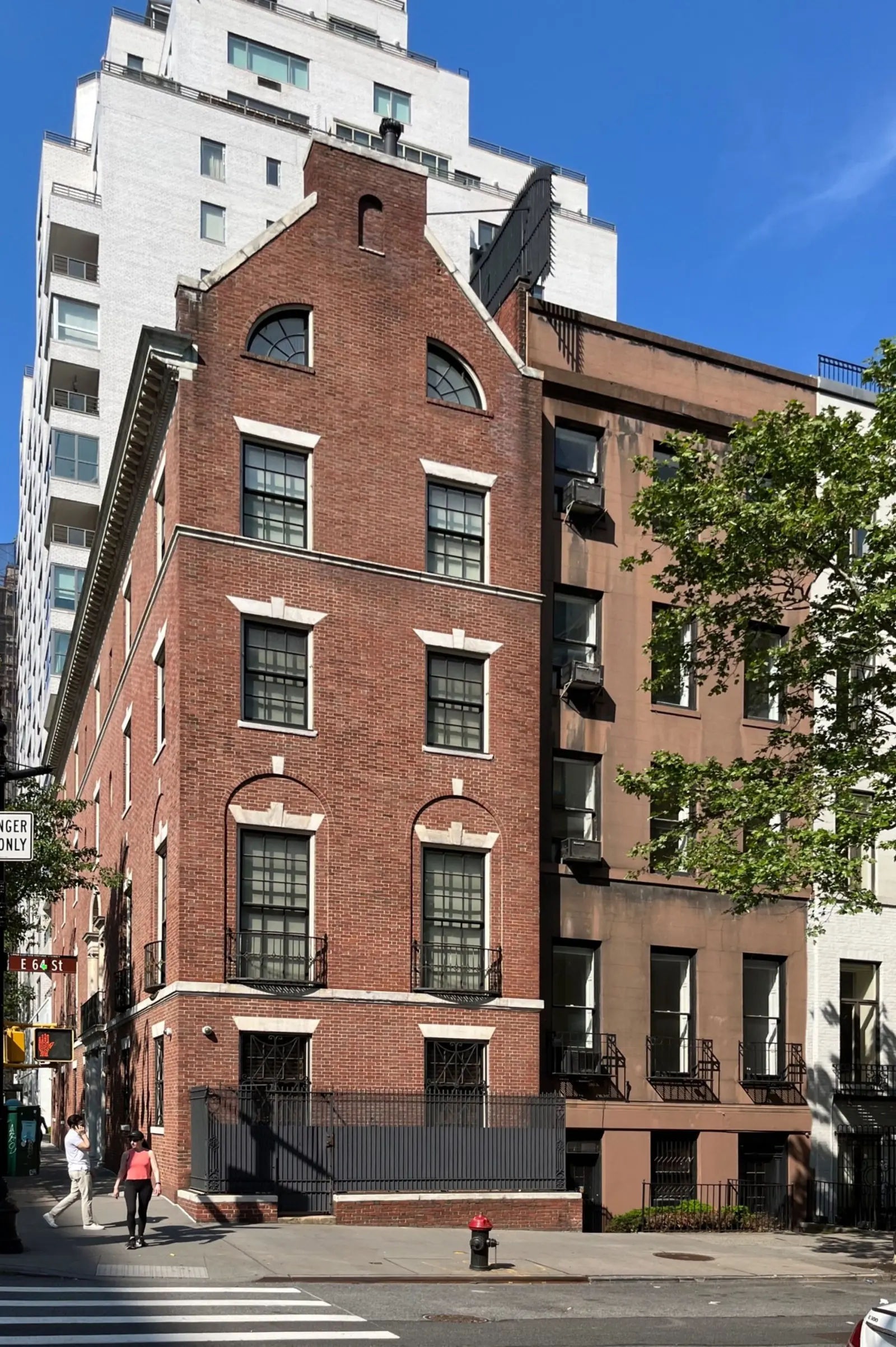 The same townhouse before, with a plain stucco front